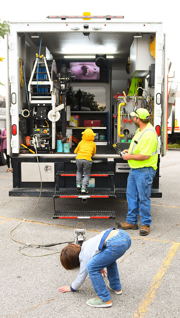 Antonio Campbell, 7, plays with a sewer camera controlled by Jarad Orey for the sensory-friendly Touch-a-Truck event